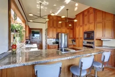 The luxurious kitchen with lighting and finished with wooden style at Littleton, CO