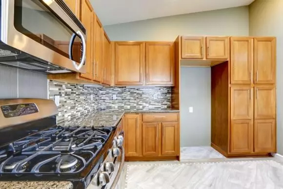 Kitchen interior with wood finishing & countertop from Rock solid custom granite at Littleton, CO.
