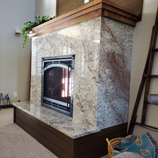 Image of a modern marble fireplace by Rock Solid Custom Granite in Durango, CO.