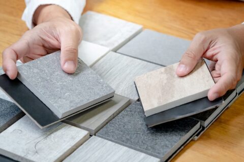 A person holding a tile