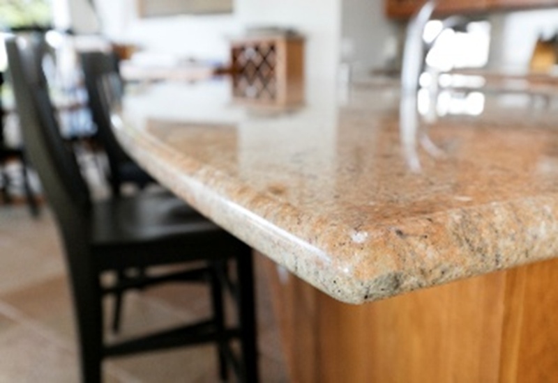 Polished granite countertop edge detail in a modern kitchen, featuring smooth rounded finish in Durango, CO
